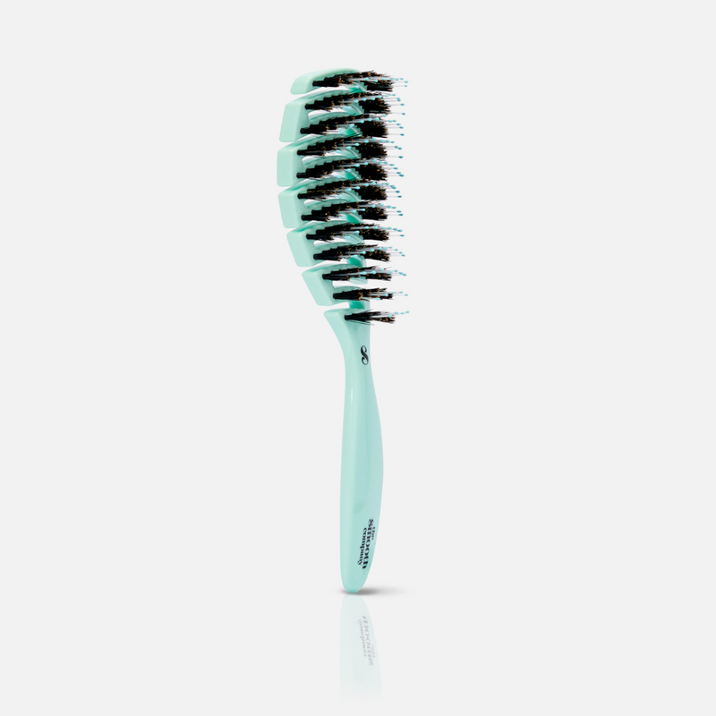 Teal hairbrush with black bristles on a light gray background